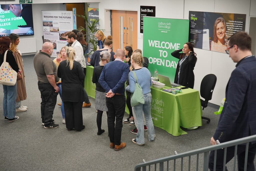 Group of visitors at open day welcome table