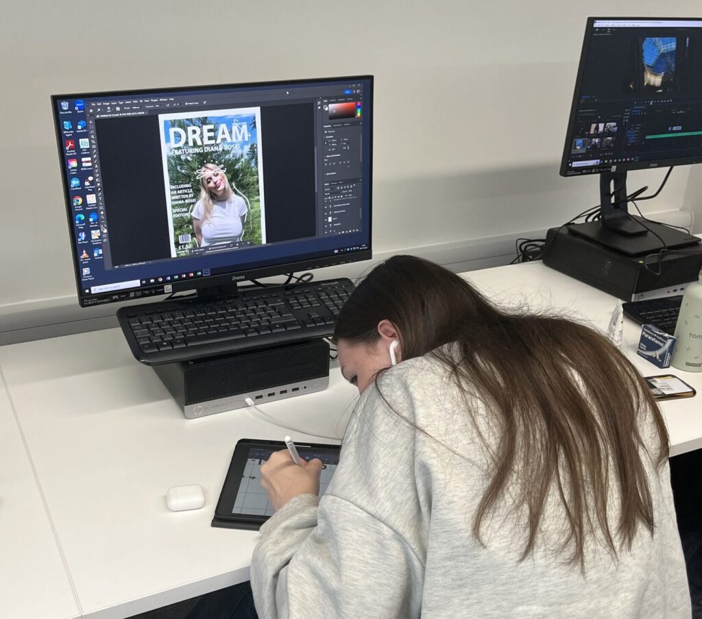Female Media student at screen making notes