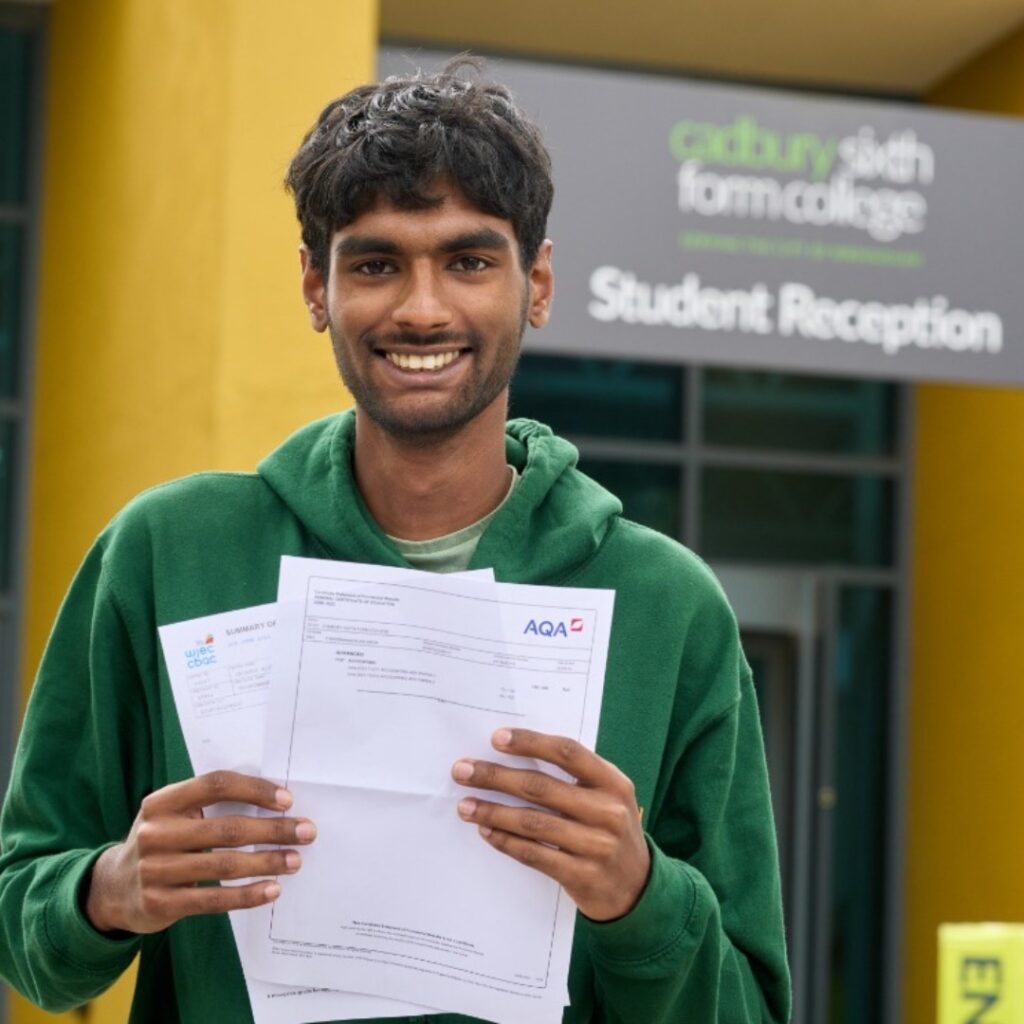 Student with results in front of the building