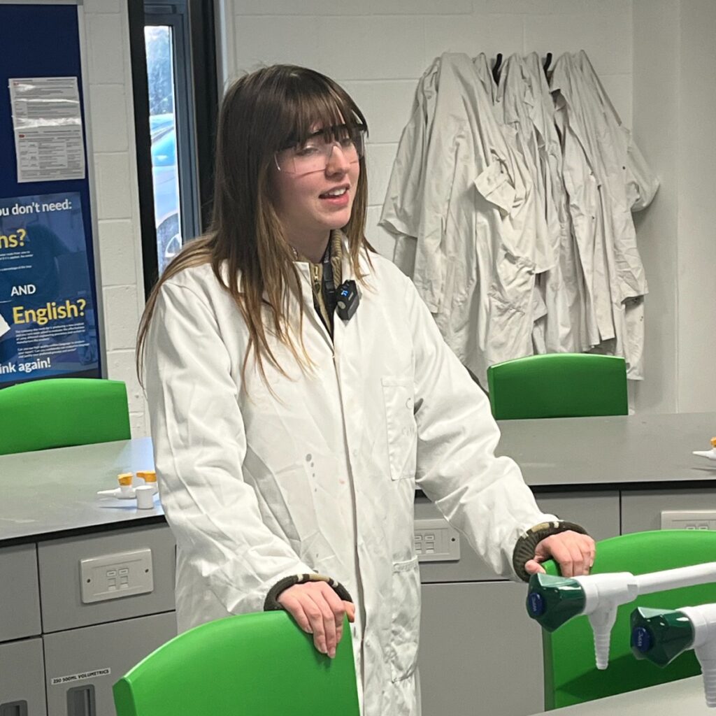 Leah in chemistry lab wearing white coat