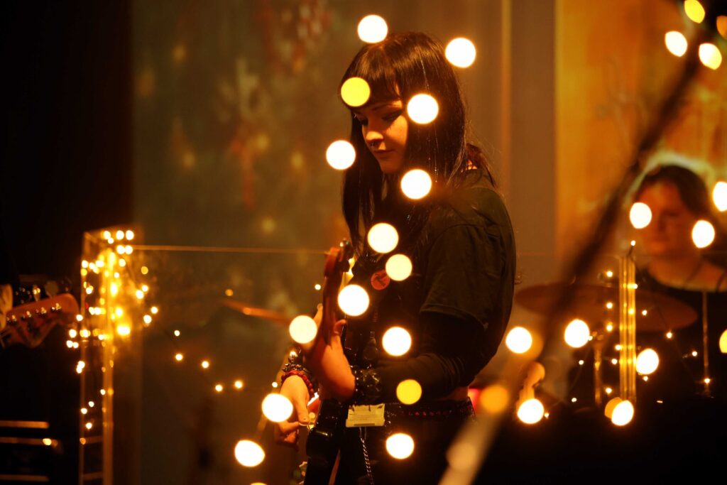 Female student with Christmas lights