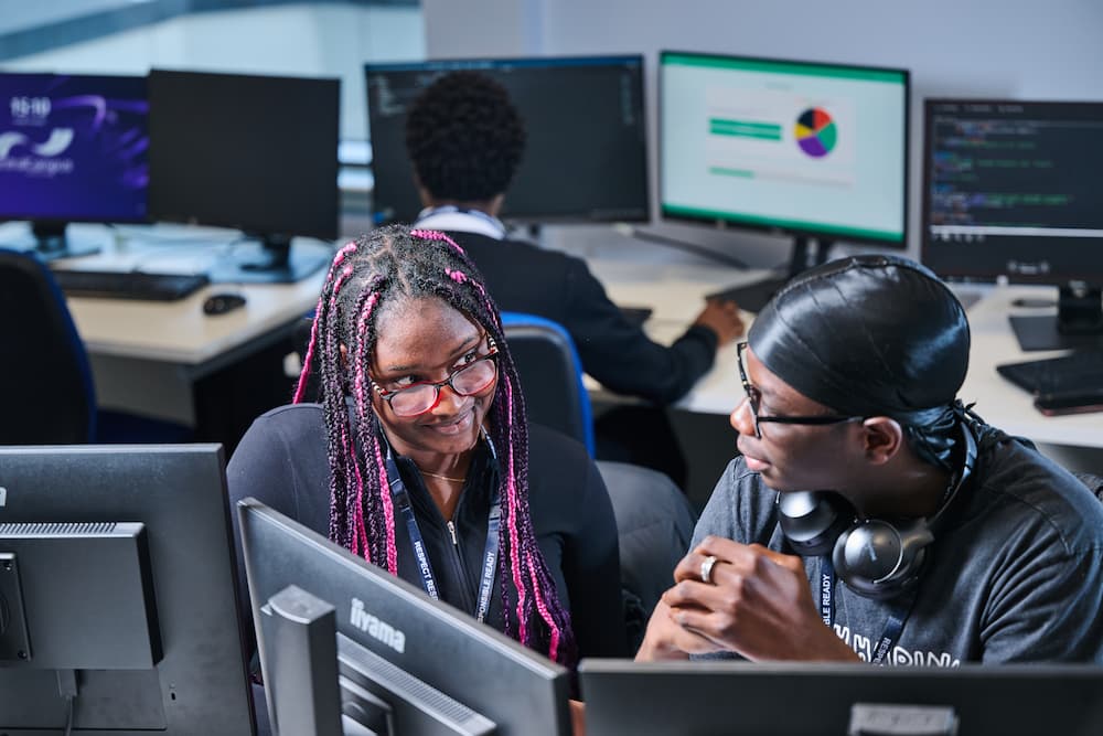 Students talking with computers
