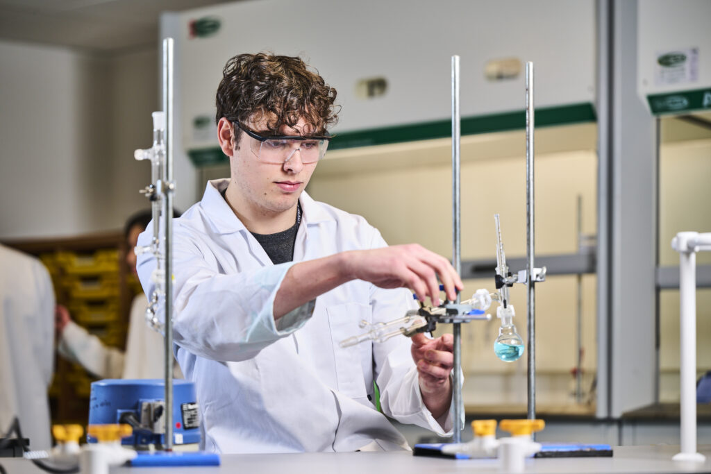 Student doing an experiment with a lab coat