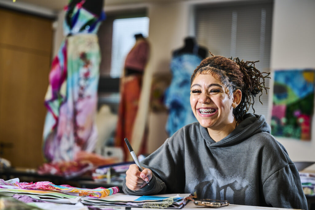 Student smiling in art lesson