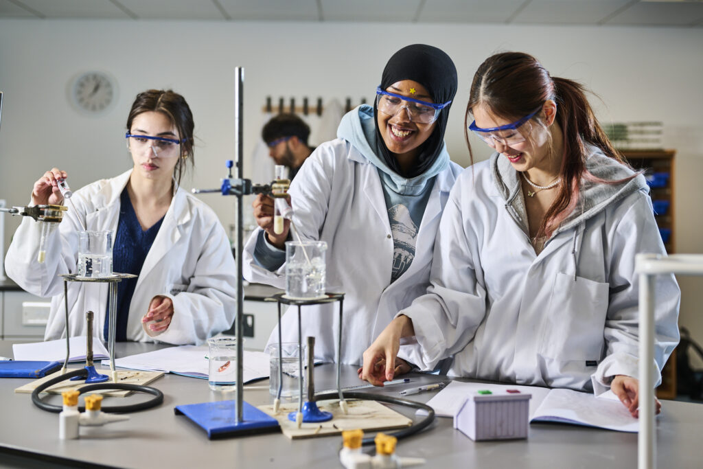 Three students with Chemistry experiment
