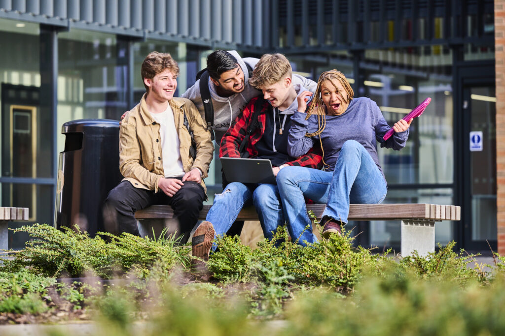 Four students enjoying themselves in the courtyard