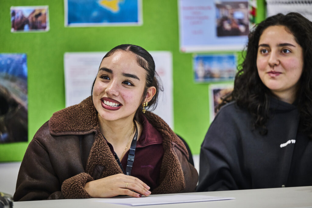 Student smiling at the front of the room