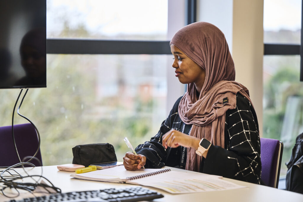 Student smiling at work