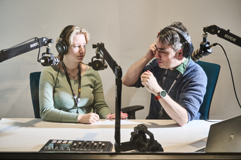Student with teacher in recording studio