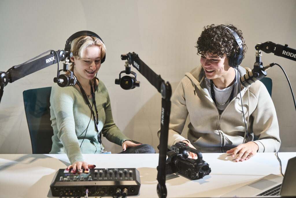 Two students with mixer in studio