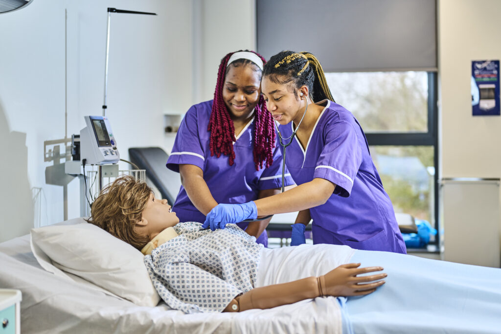 Two students with mannequin for Health course