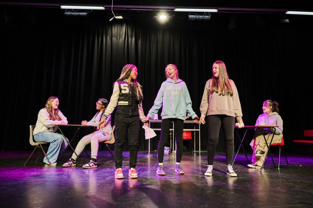 Students singing in performing arts lesson