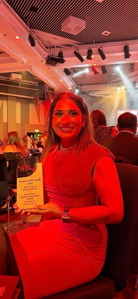 Former student holding her Young Professional of the Year Award