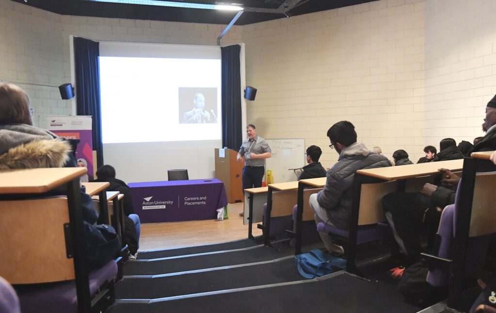 Speaker talks to students in lecture theatre